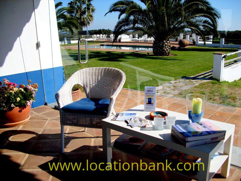 Terrace with view at the pool and the garden