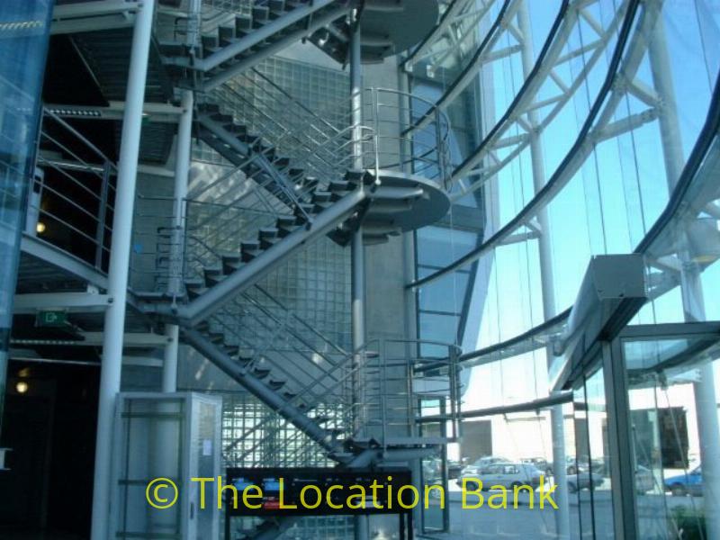 Hichtec office building with beautifull stairs and glass elevator and a terras with a view at the airport