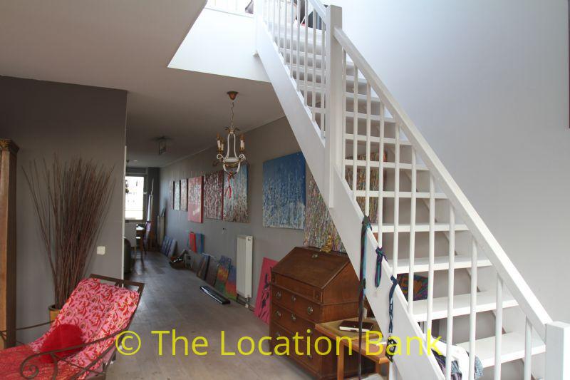 Open staircase in the living room mounted against side wall.