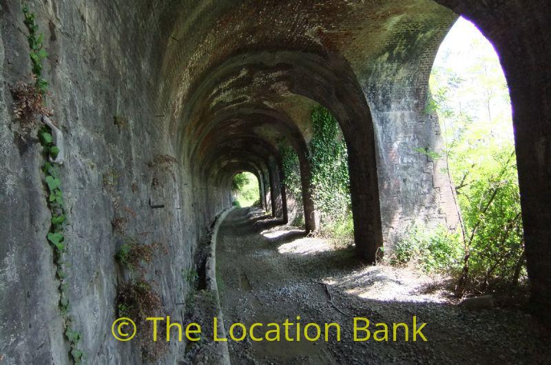 Deserted abandoned railway tunnel with no rail