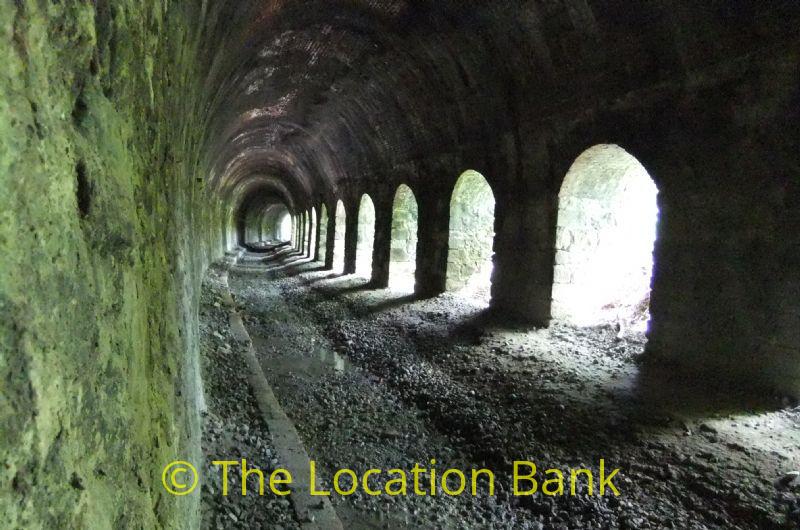 Deserted abandoned railway tunnel with no rail