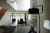 living with staircase and piano