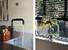 Schwarze Küchenarmatur auf einem Spülbecken neben einem Fenster mit Jalousien und Orchideen laufen.